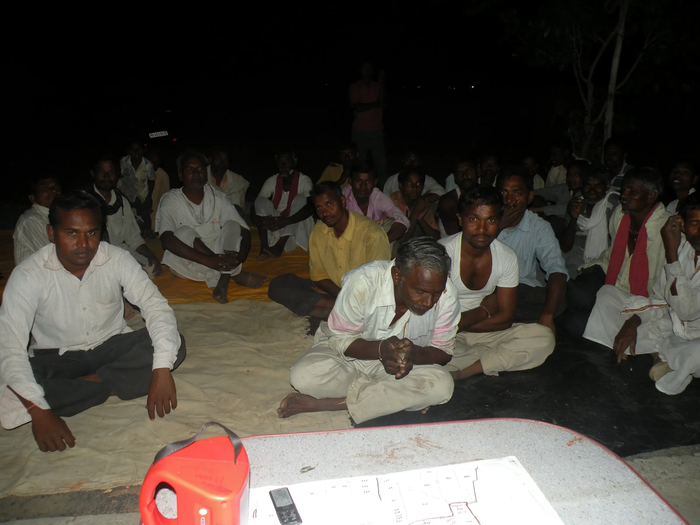 Farmers meet in the evening to learn about organic farming.