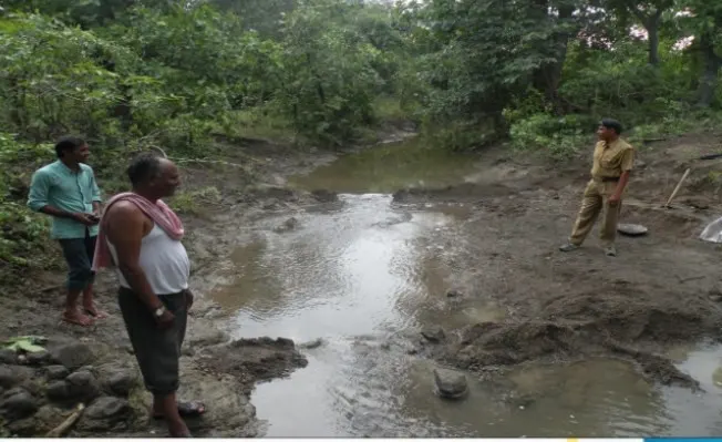 Villagers clean a forest stream by shramdan, so wildlife has water in summer.